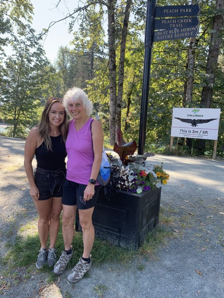 Two women, Hannah and Elaine, stand outside wearing athletic clothing