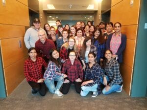 Faith and her classmates of the Education Assistant Program standing proudly in front of Stenberg College