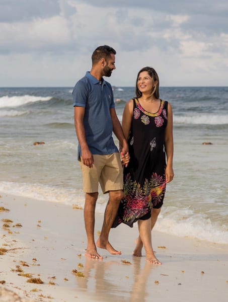 Harpreet walking with husband on a canadian beach. Coming to Canada was a good decision after all.