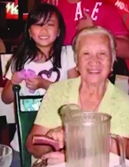 Justine as a child with her grandmother in the Philippines.