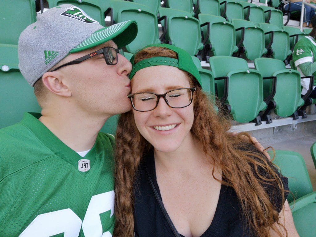 Taryn Rowland and the love of her life, Justin cheering on the Roughriders.
