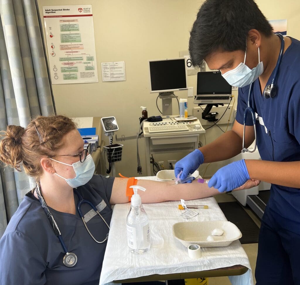Taryn Rowland  practices phlebotomy as part of her lab experience. 