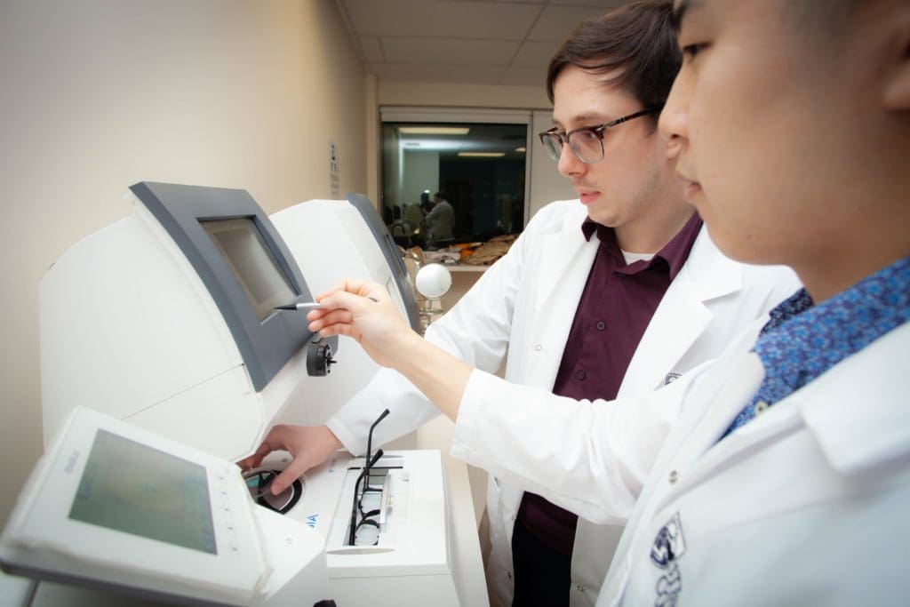 Gabriel gains hands-on experience using a Lens Edger. Photo: Gurjant Mann