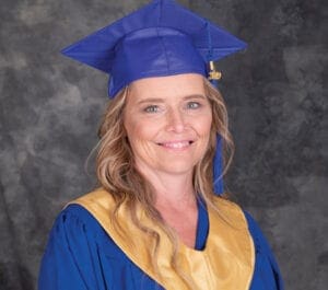 Michelle wearing her Student of the Year gown. She graduated at 50 and now helps other wounded women to heal.