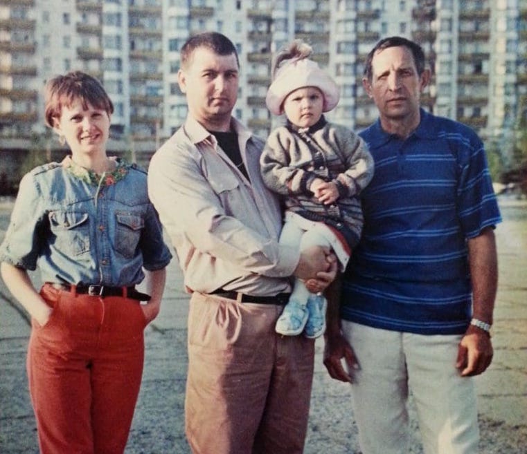 Oksana and her family in front of their home in Ukraine, which is now “completely erased.”