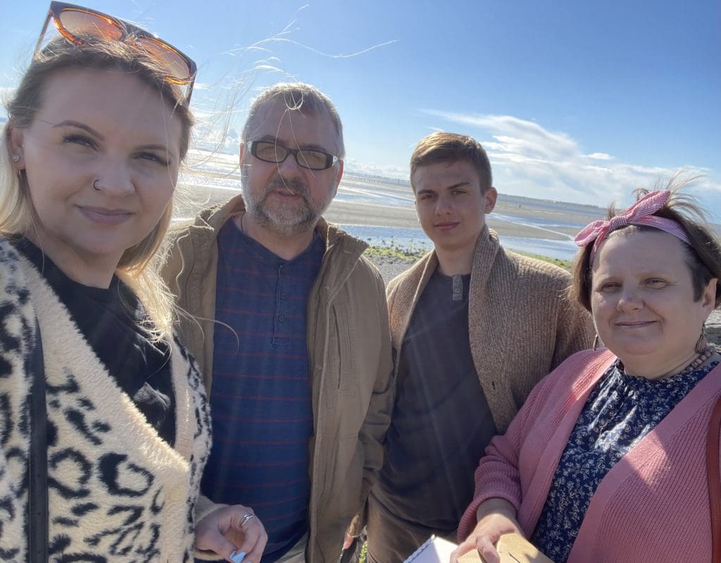 Oksana and her family at the beach smiling.