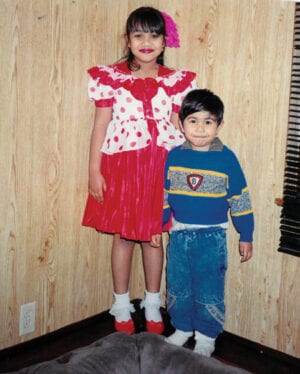 V and her brother stand happily in Fiji, before coming to Canada.