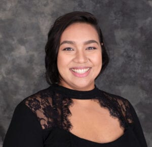 V smiles proudly to the camera at her graduation from the Counselling Diploma Program.