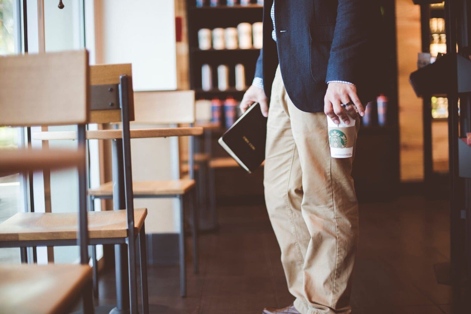 Photo of man holding Starbucks cup