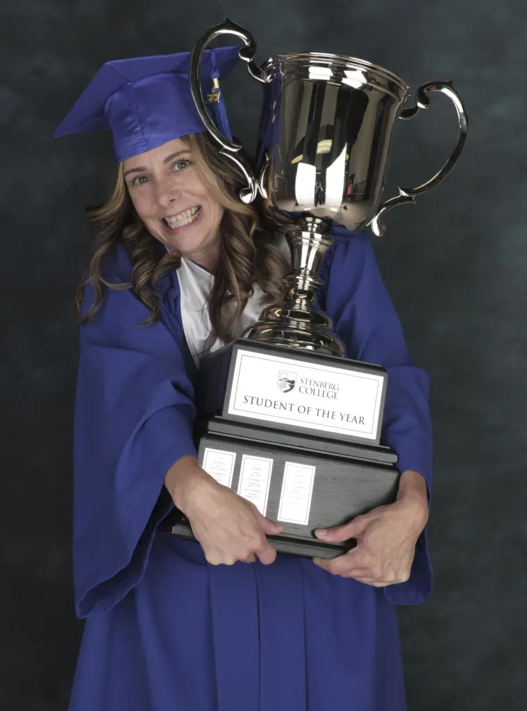 student of the year winner, renee trogi, holding her trophy