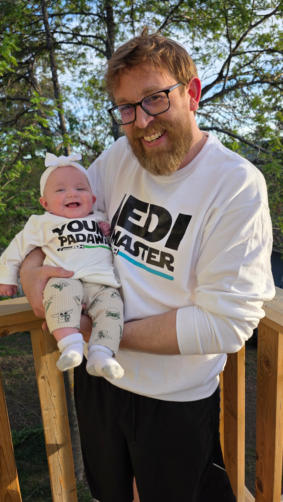Tim is the happiest carrying his newborn
